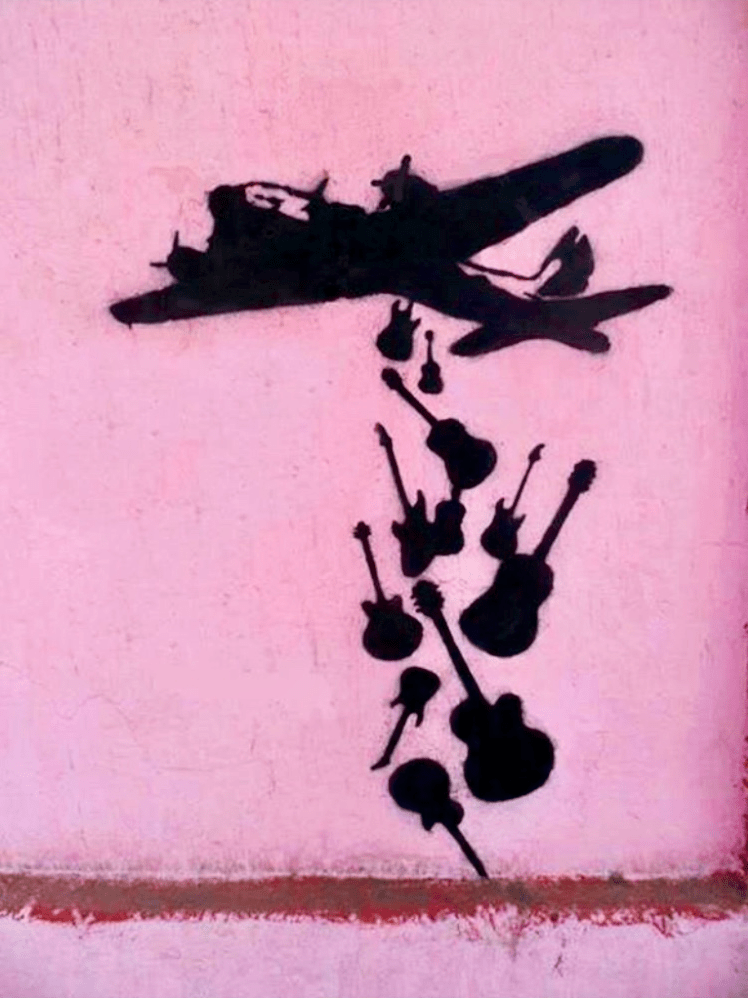Silueta negra de avión lanzando guitarras sobre fondo rosa